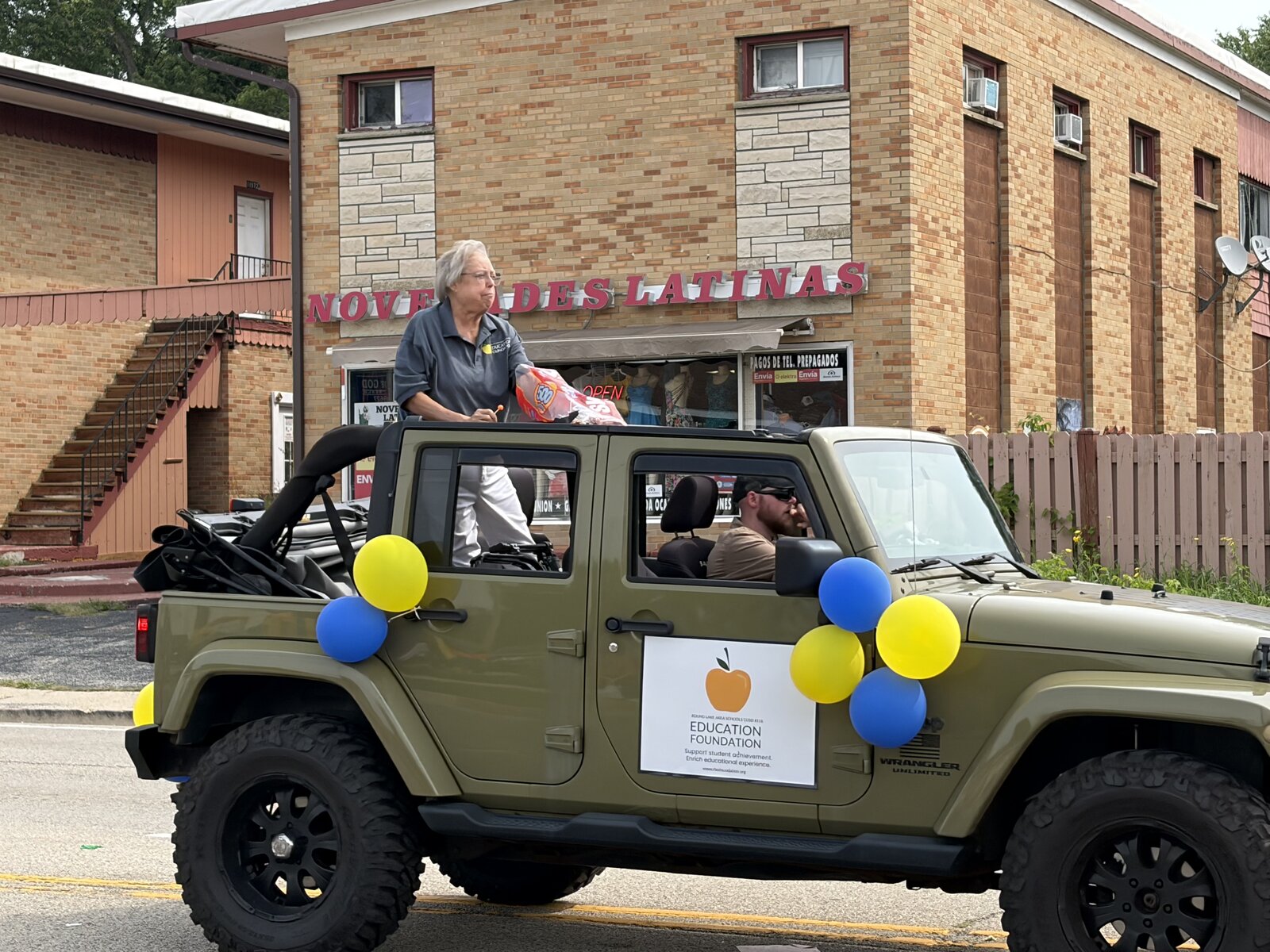 Dr. Jeanne Kearby tosses candy to the crowd from the Foundation's decorated Jeep
